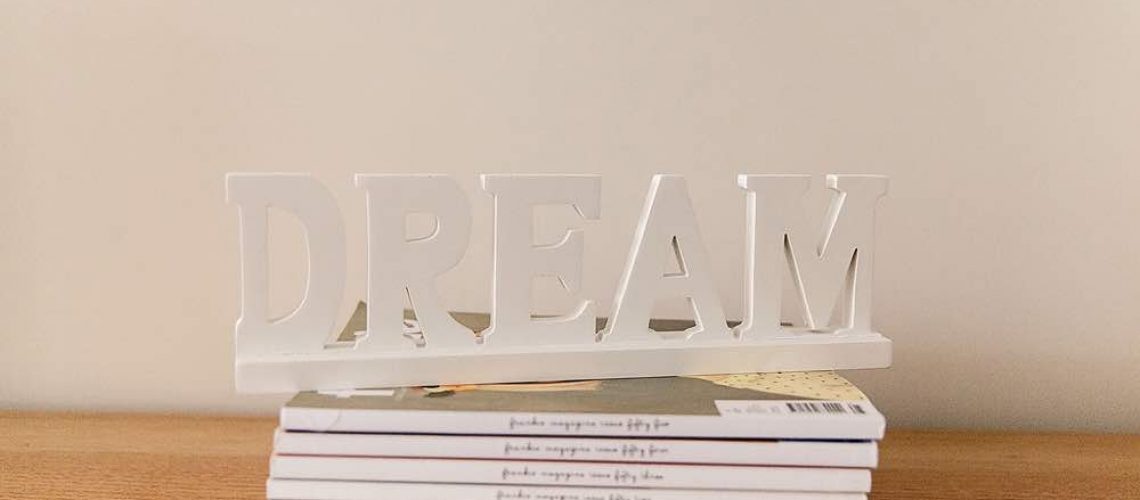Dream sign on stack of magazines